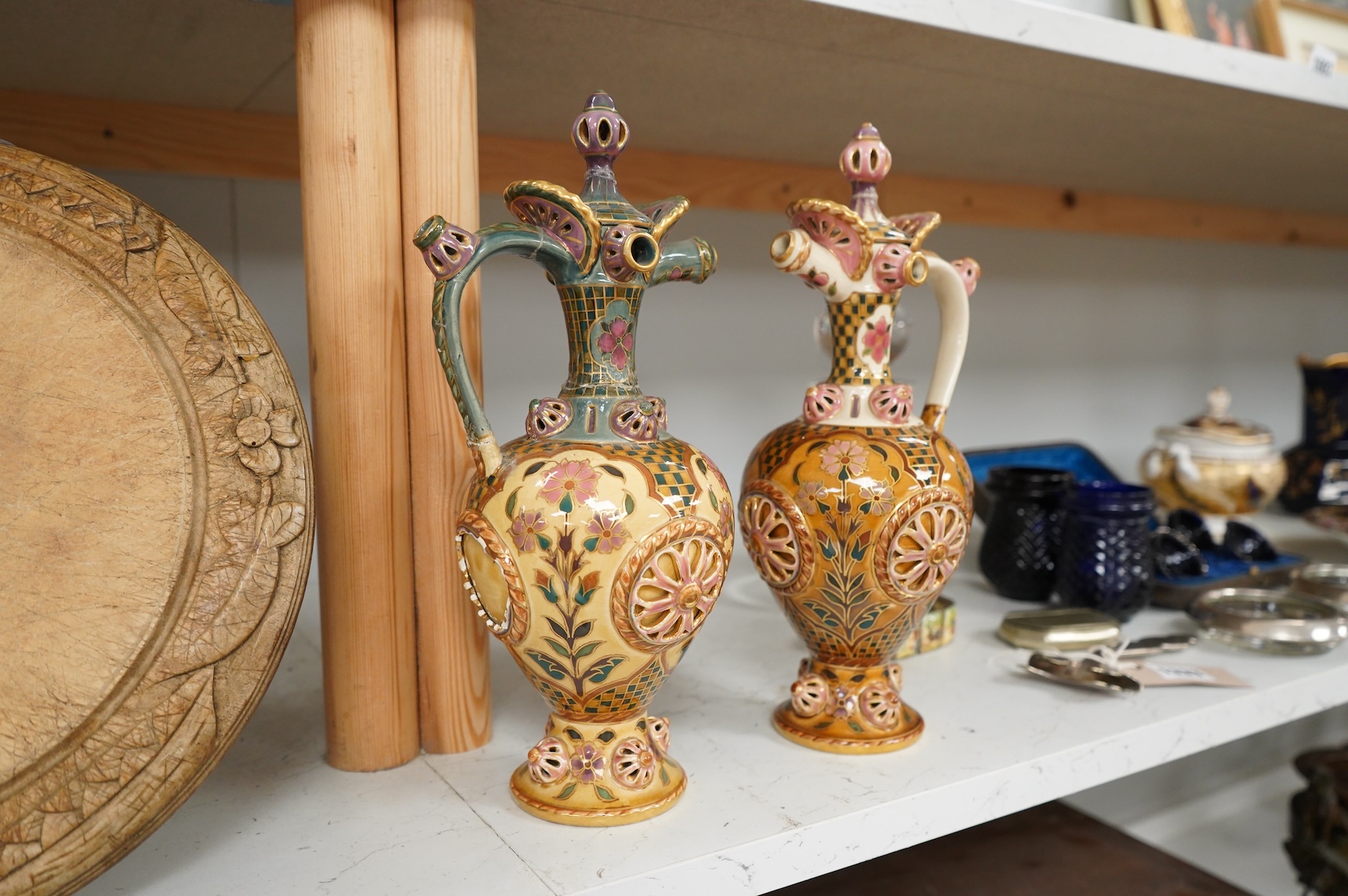 Two Zsolnay Persian inspired jugs / ewers and covers, stamped to the bases 29cm high